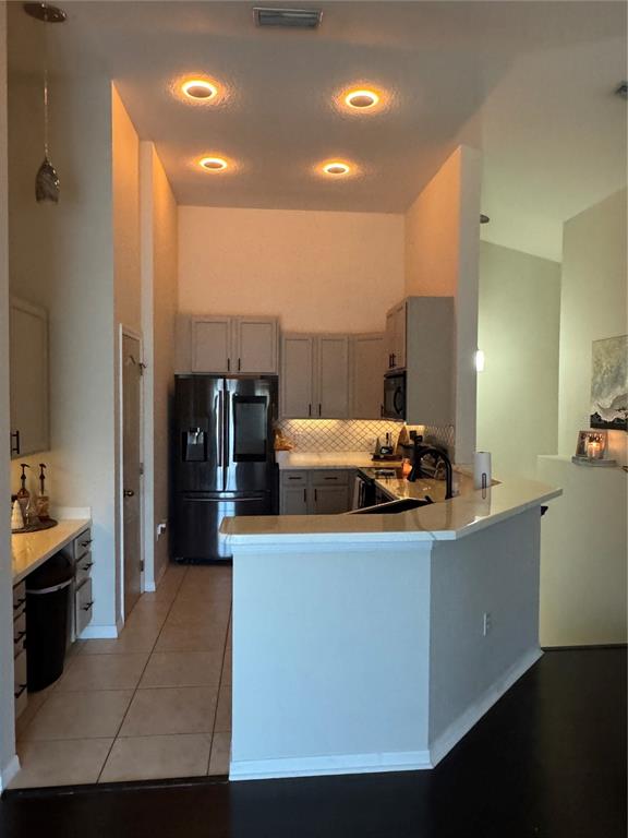 2318 Tanbark Ridge Place, Unit 2318 Plant City, FL 33563 - Photo 18 of 64 a kitchen with stainless steel appliances kitchen island sink refrigerator and stove
