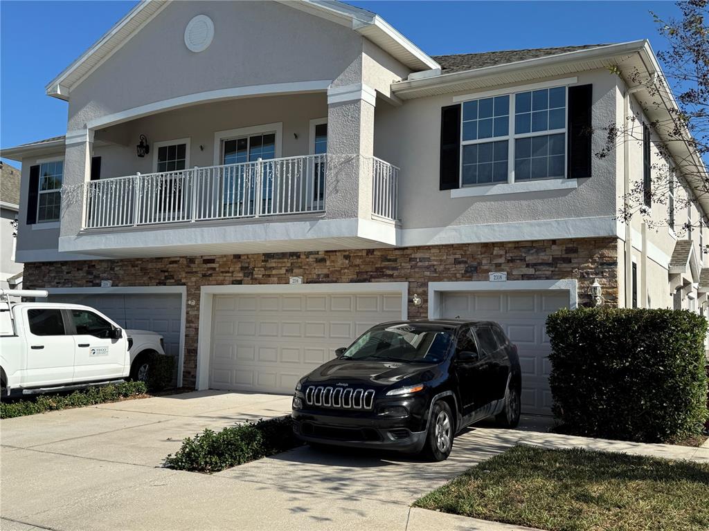 2318 Tanbark Ridge Place, Unit 2318 Plant City, FL 33563 - Photo 2 of 64 a car parked in front of a building