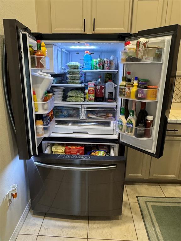 2318 Tanbark Ridge Place, Unit 2318 Plant City, FL 33563 - Photo 23 of 64 a kitchen with stainless steel appliances granite countertop a stove a refrigerator and a sink