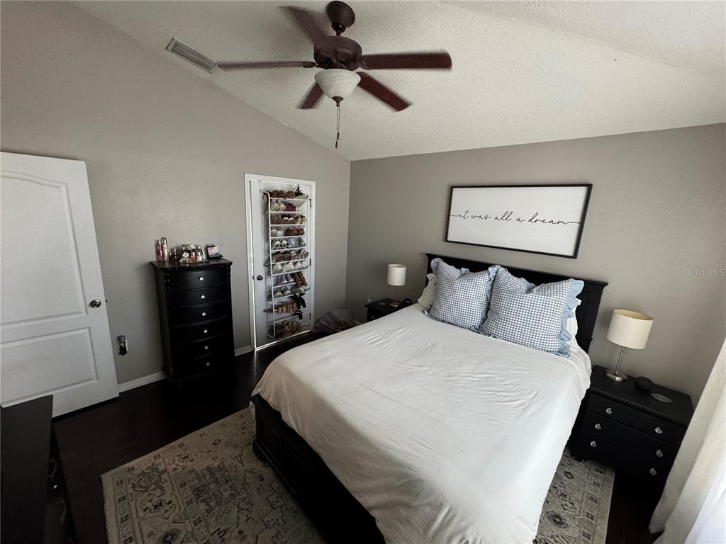 2318 Tanbark Ridge Place, Unit 2318 Plant City, FL 33563 - Photo 33 of 64 a bedroom with a bed and a walk in closet