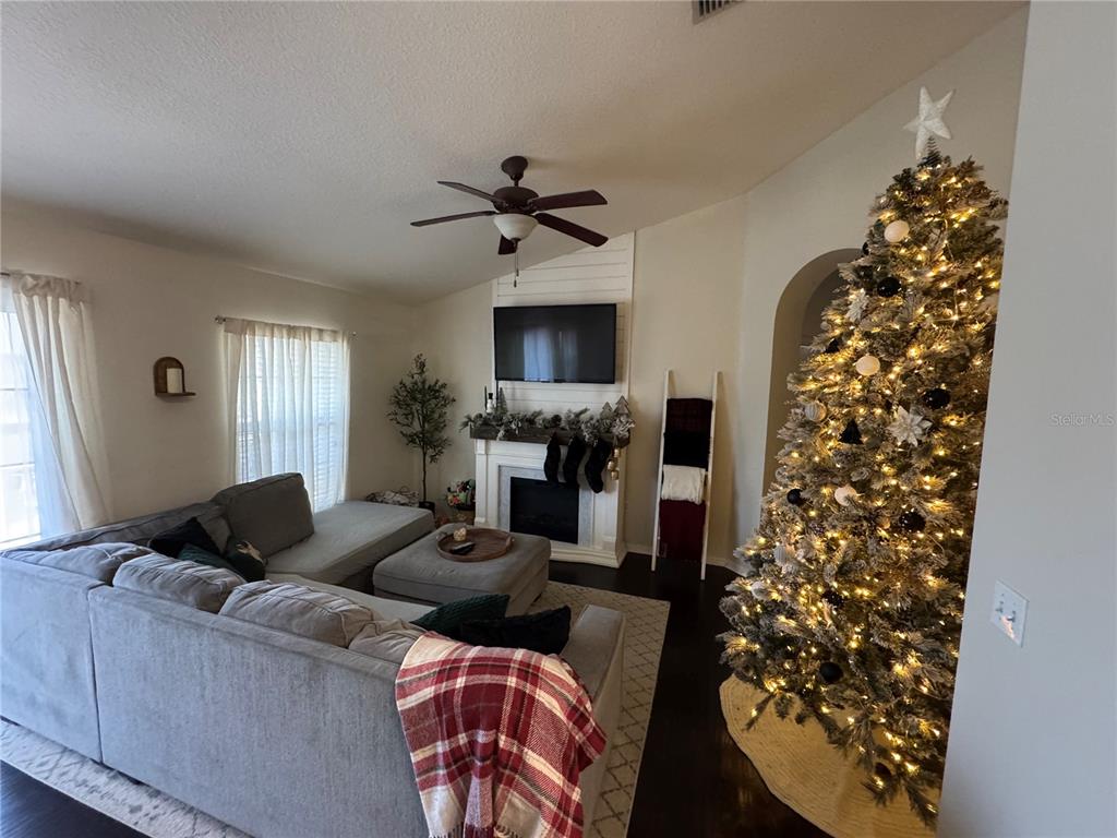 2318 Tanbark Ridge Place, Unit 2318 Plant City, FL 33563 - Photo 63 of 64 a living room with furniture and a fireplace