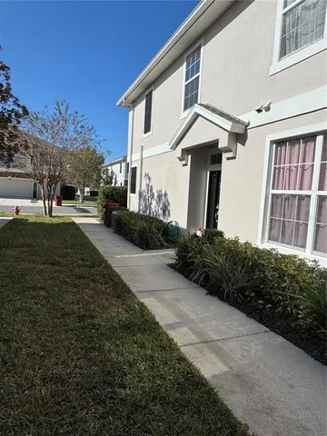 a front view of a house with a yard and trees