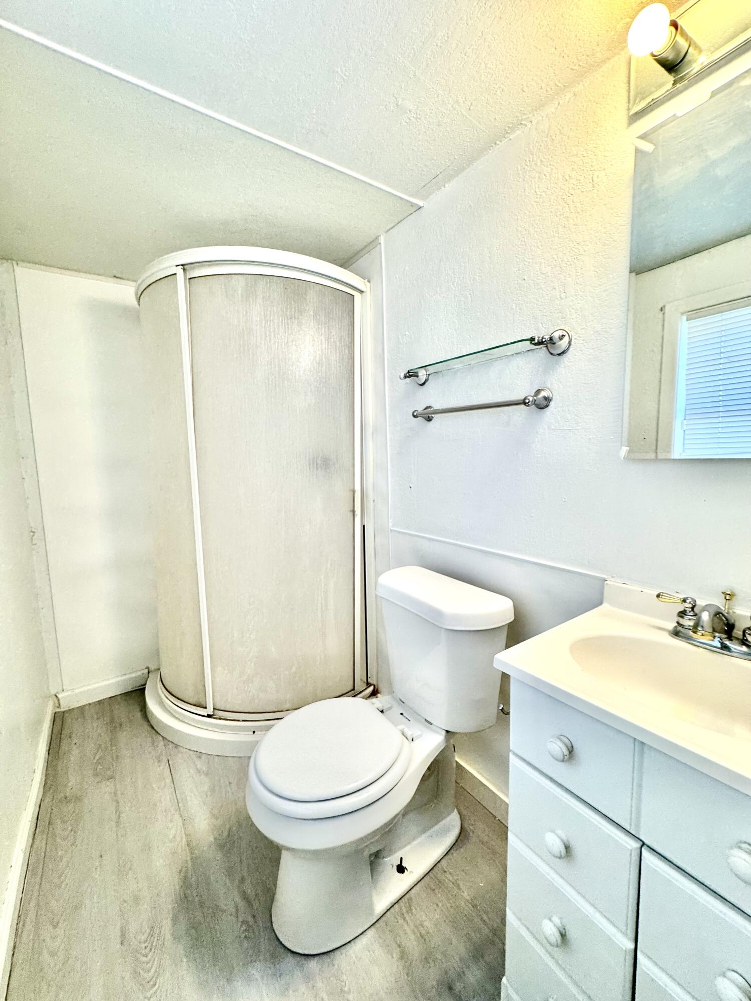 2305 27th Street, Unit REAR Lubbock, TX 79411 - Photo 6 of 8 a bathroom with a toilet a sink and shower