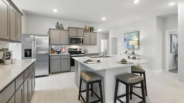 a kitchen with sink cabinets and stove