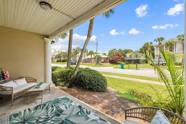 a patio with glass top table and chairs