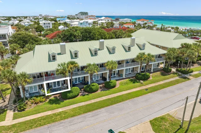 an aerial view of a house with a garden and lake view