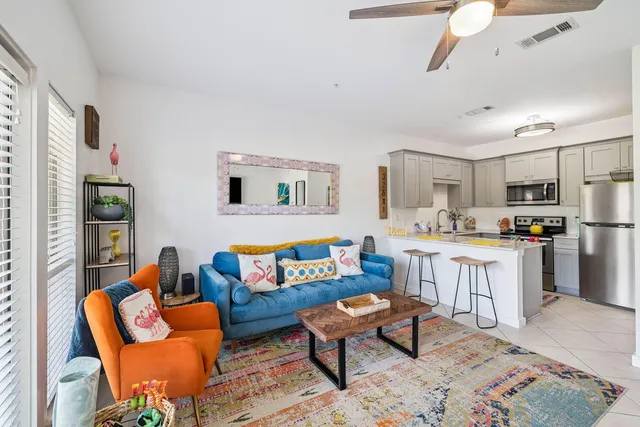 a living room with furniture and a kitchen view