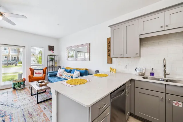 a kitchen with a sink cabinets and wooden floor