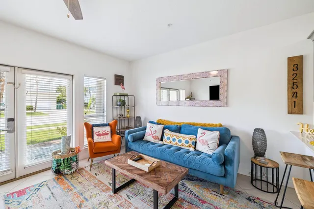 a living room with furniture and a potted plant