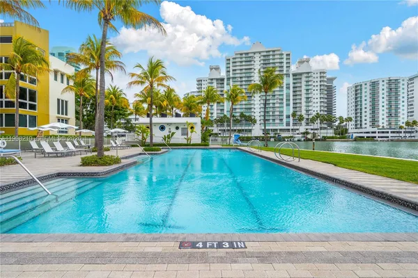 a view of swimming pool with outdoor seating and city view