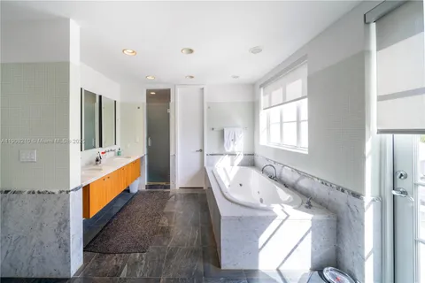 a bedroom with furniture and a large window