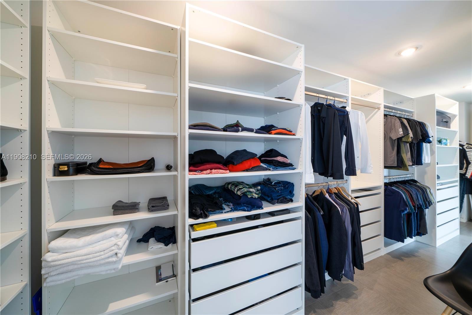230 Water Way Miami Beach, FL 33141 - Photo 19 of 42 a view of walk in closet with clothes and shoes