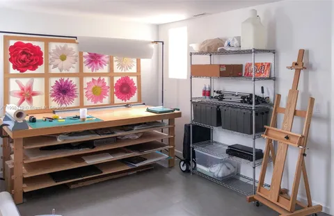 a view of a tennis ground with large trees