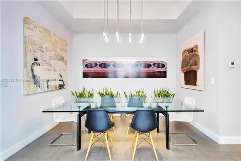 a view of a dining room with furniture and chandelier