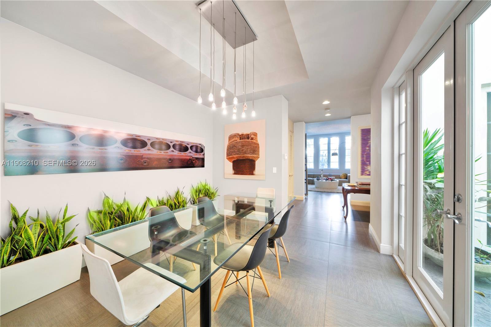 230 Water Way Miami Beach, FL 33141 - Photo 6 of 42 a view of a dining room with furniture and a chandelier