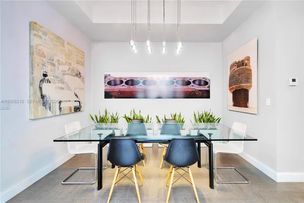 a view of a dining room with furniture and chandelier