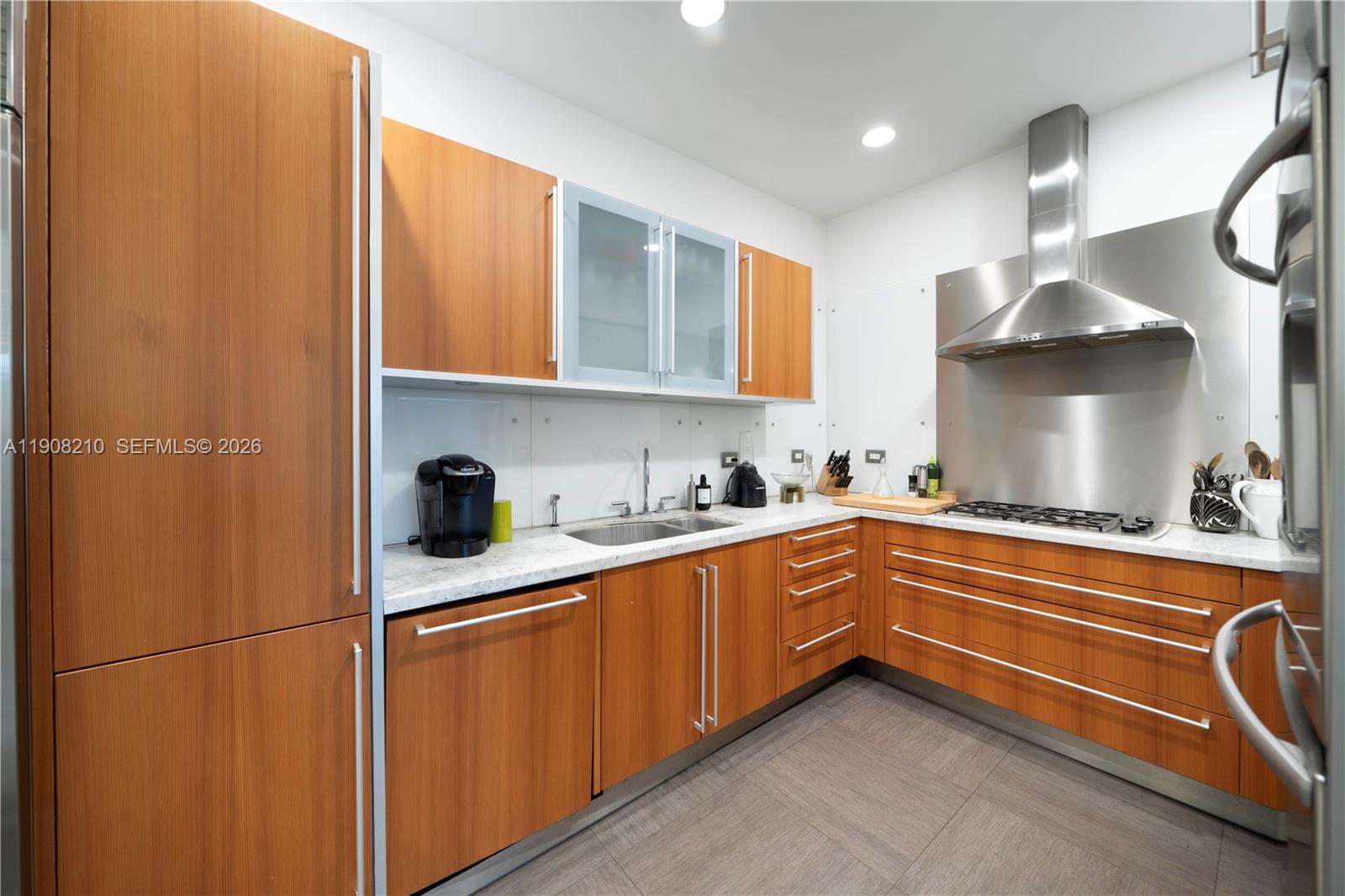 230 Water Way Miami Beach, FL 33141 - Photo 10 of 42 a kitchen with stainless steel appliances granite countertop a sink a stove and a refrigerator