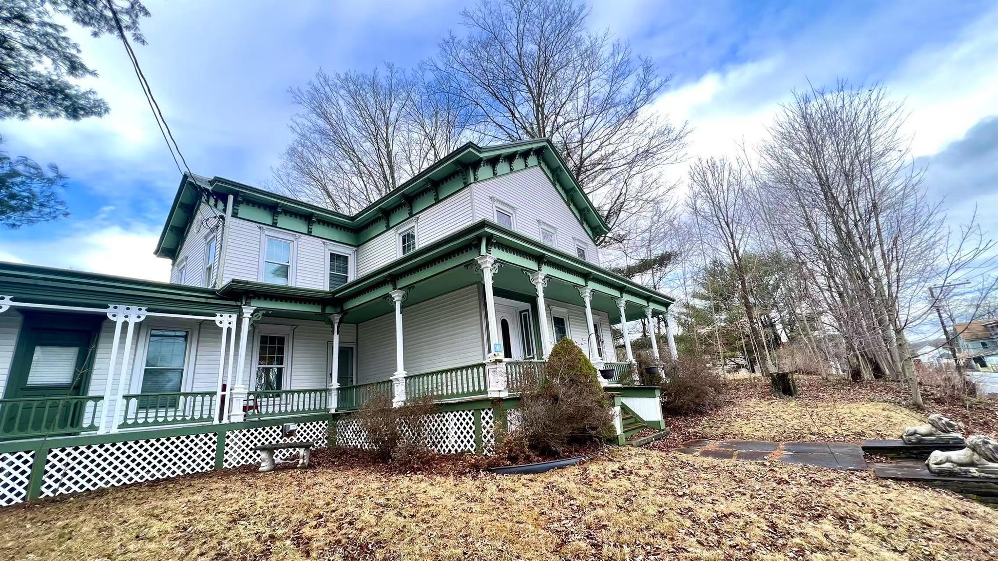 View of side of home featuring covered porch