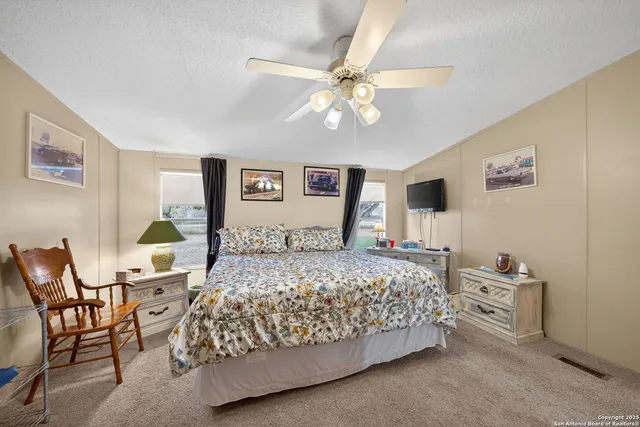 a bedroom with a bed a dresser and chair