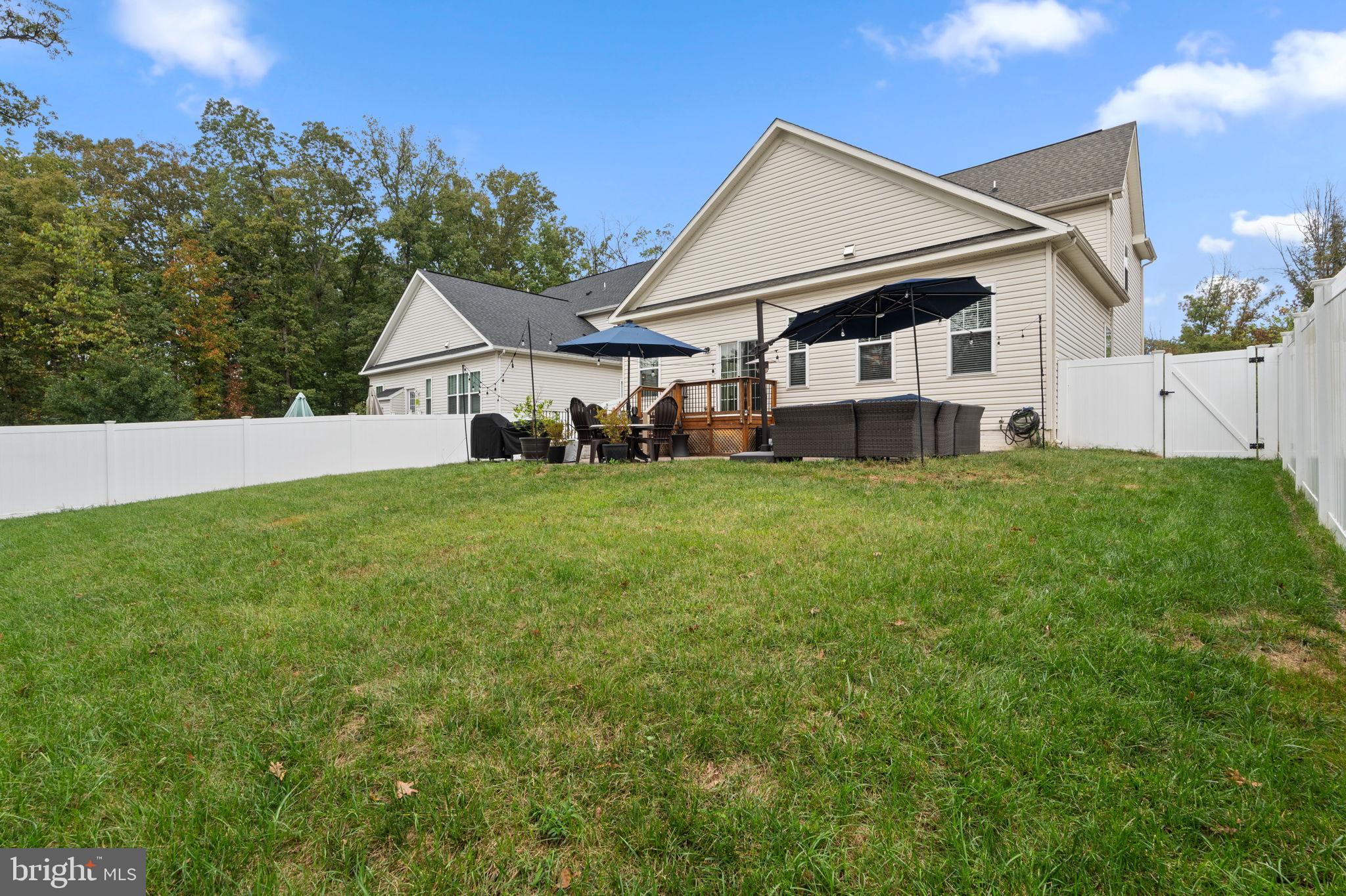 12203 Aster Road Bristow, VA 20136 - Photo 44 of 55 Serene backyard retreat with lush greenery.