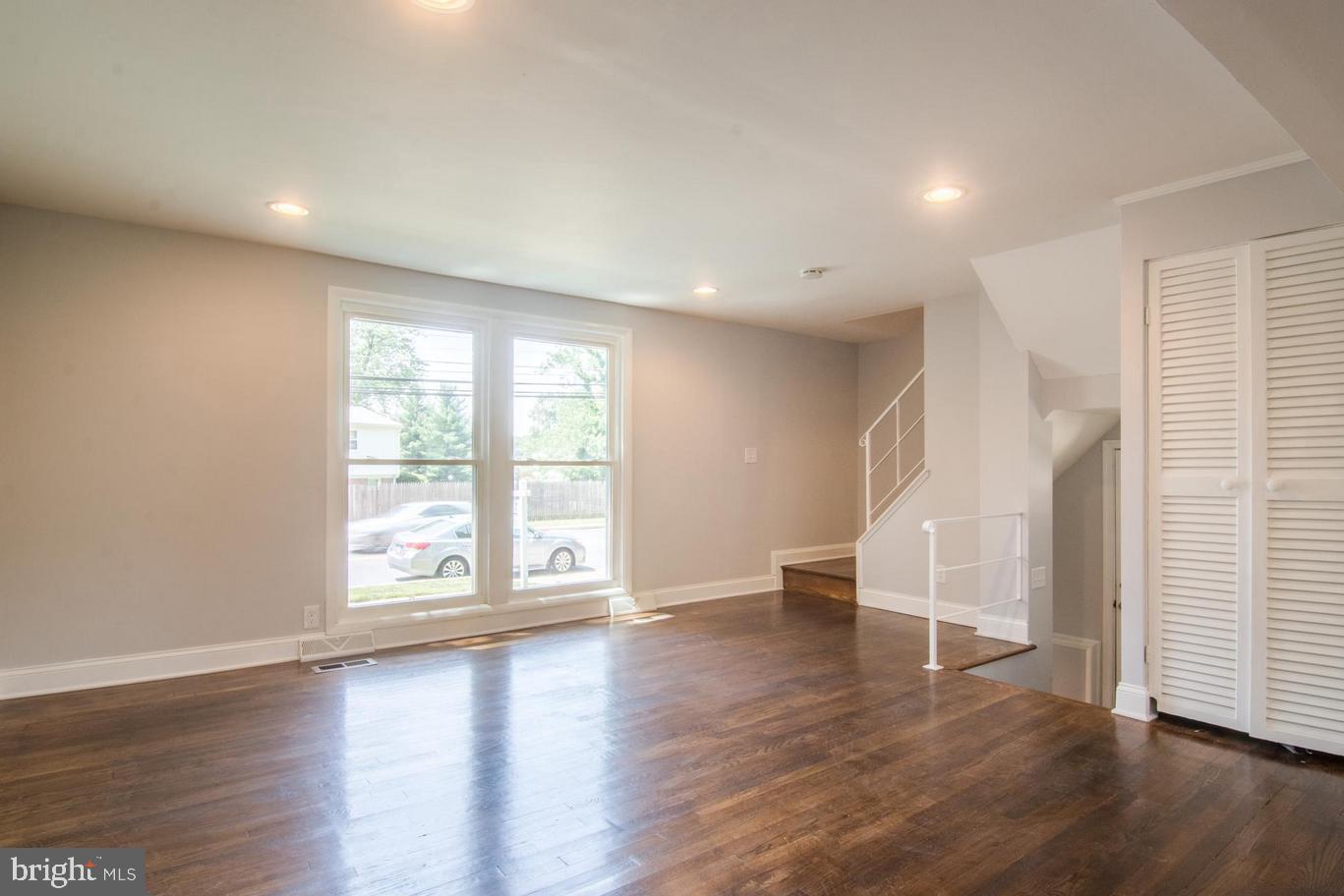 2436 Smith Avenue Baltimore, MD 21209 - Photo 3 of 14 an empty room with wooden floor and windows
