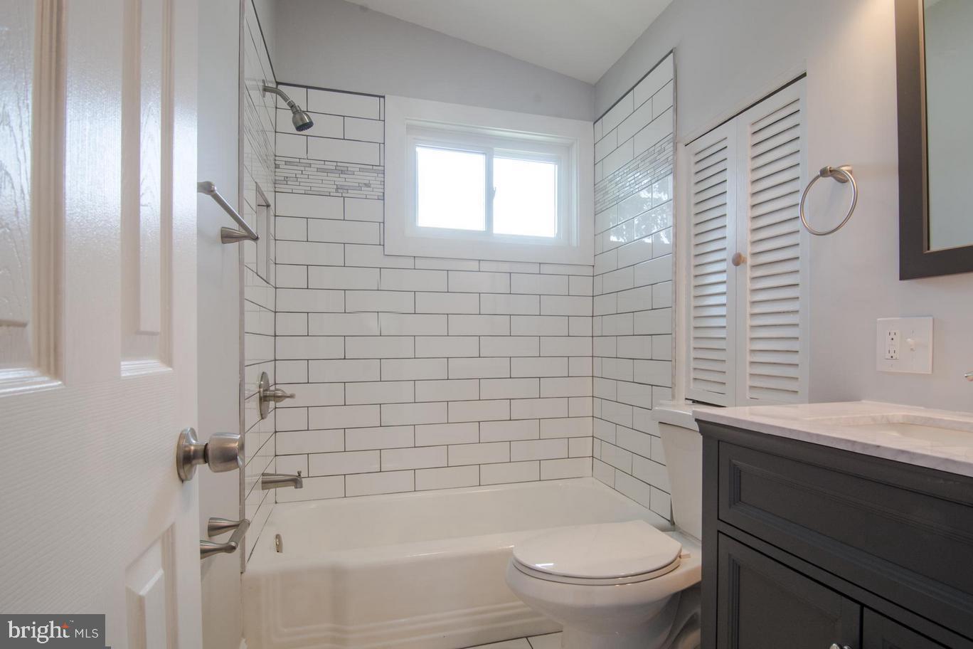 2436 Smith Avenue Baltimore, MD 21209 - Photo 4 of 14 a bathroom with a bathtub and sink