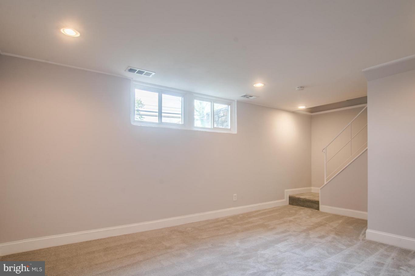 2436 Smith Avenue Baltimore, MD 21209 - Photo 9 of 14 an empty room with windows