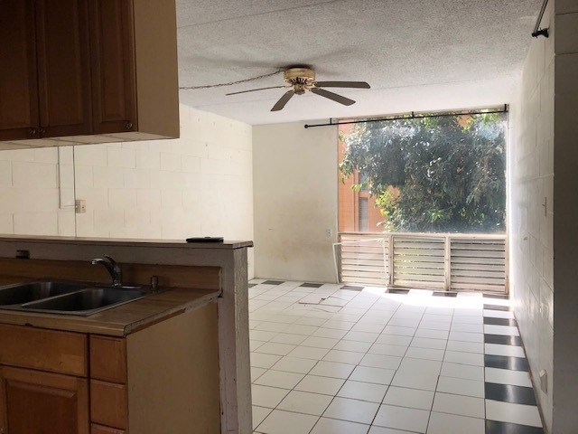 3676 Lower Honoapiilani Road, Unit G203 Lahaina, HI 96761 - Photo 12 of 14 a kitchen with a sink and a window