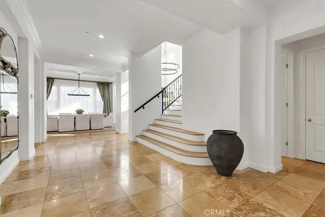 a living room with furniture a rug and a chandelier
