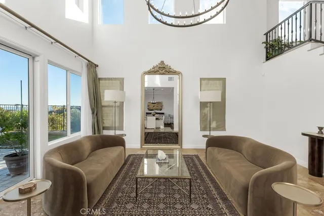 a dining room with table wooden floor and a chandelier