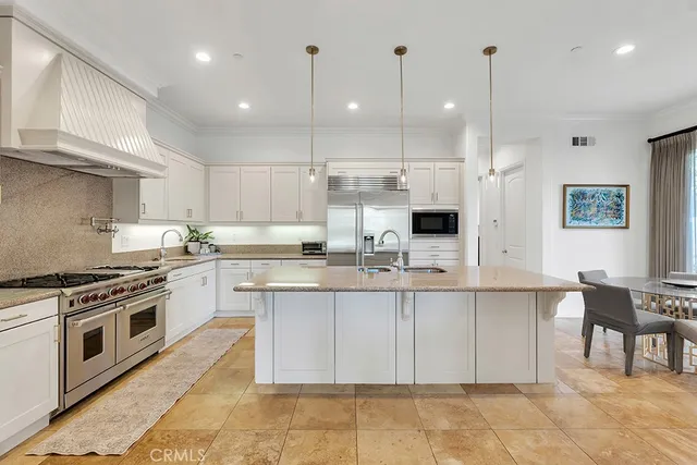 a kitchen with stainless steel appliances granite countertop a stove and a sink