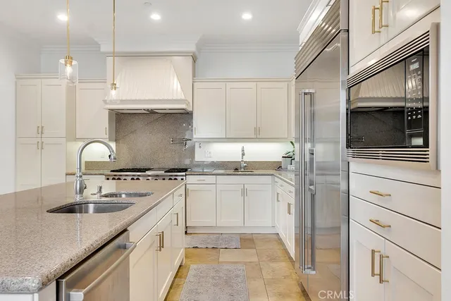 a kitchen with a stove a sink a center island and furniture