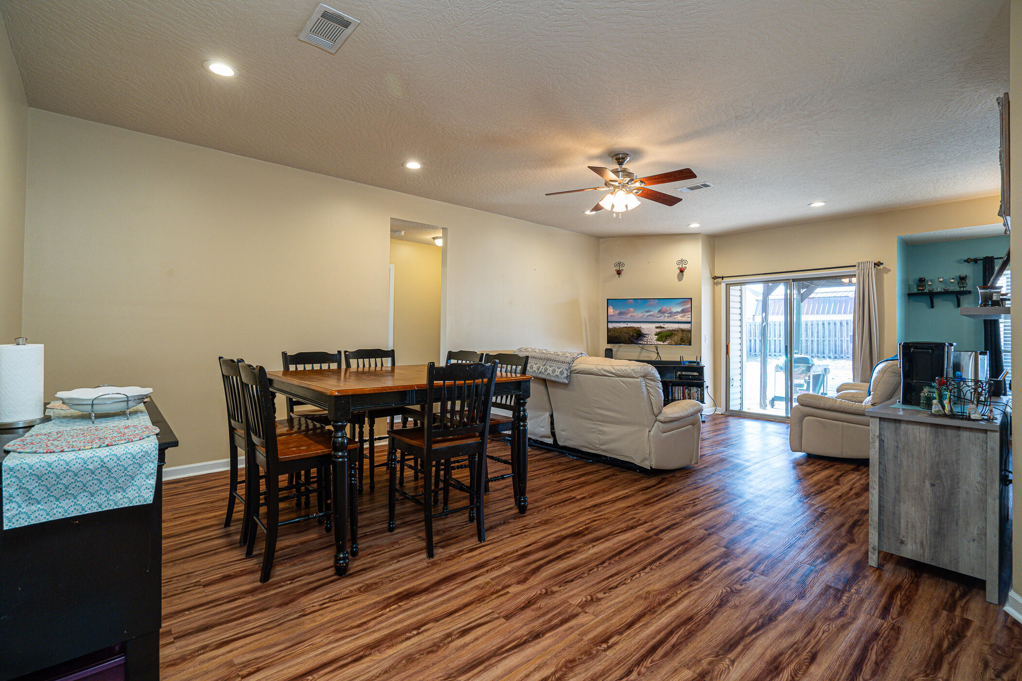 5269 Moore Loop Crestview, FL 32536 - Photo 15 of 36 a living room with furniture a wooden floor and a chandelier