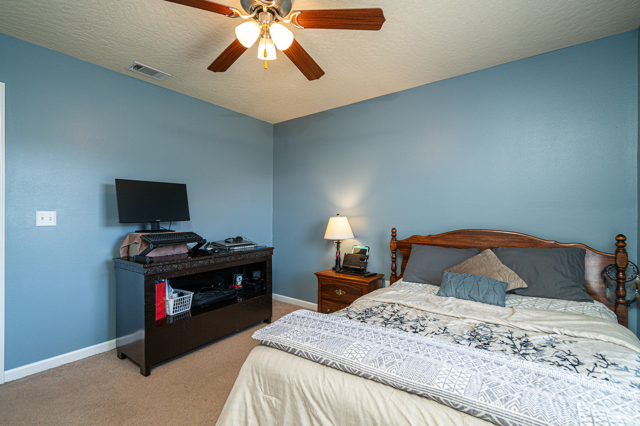 5269 Moore Loop Crestview, FL 32536 - Photo 17 of 36 a bedroom with a bed and a flat screen tv