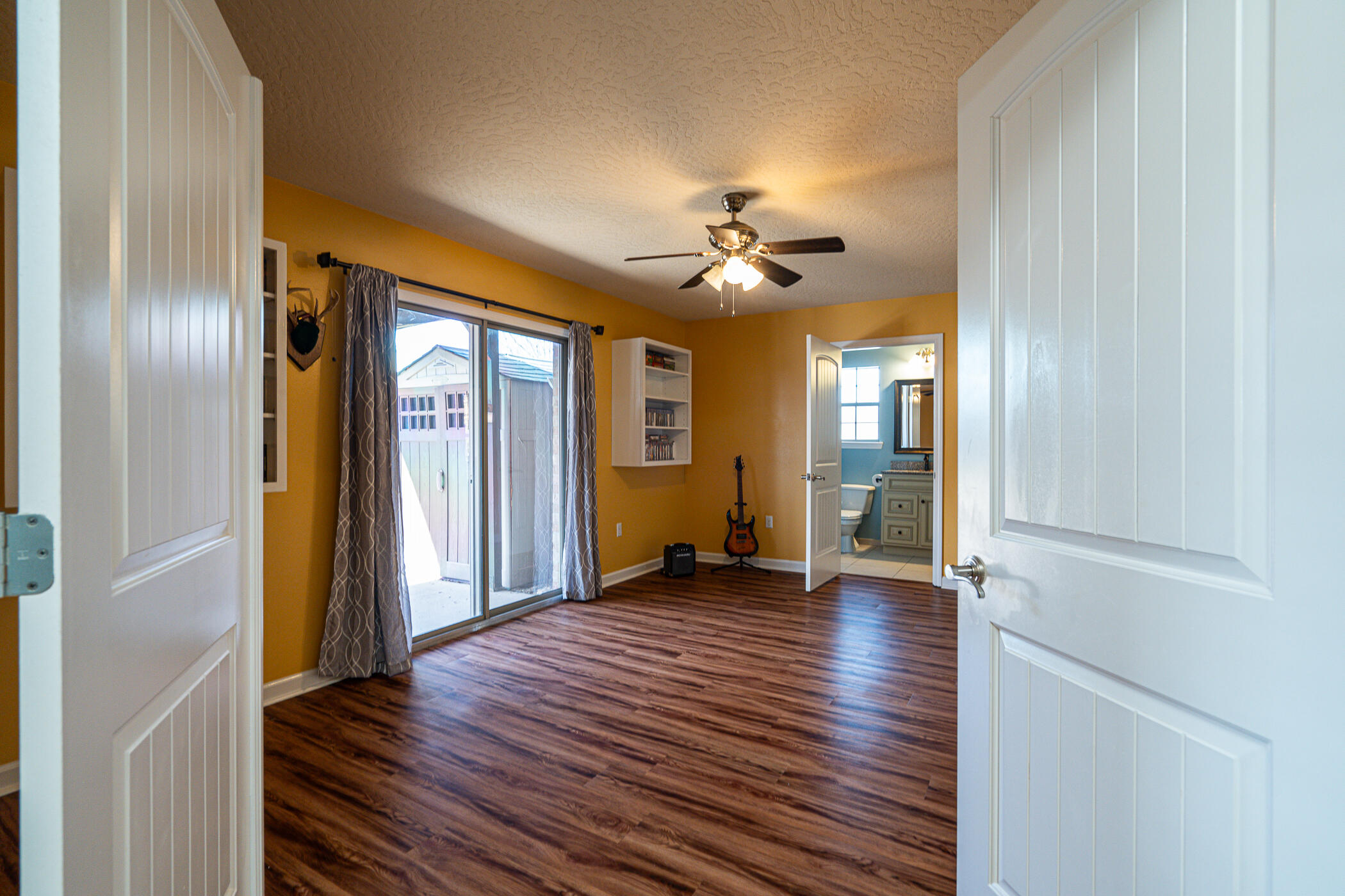 5269 Moore Loop Crestview, FL 32536 - Photo 19 of 36 a view of an empty room with a window and wooden floor