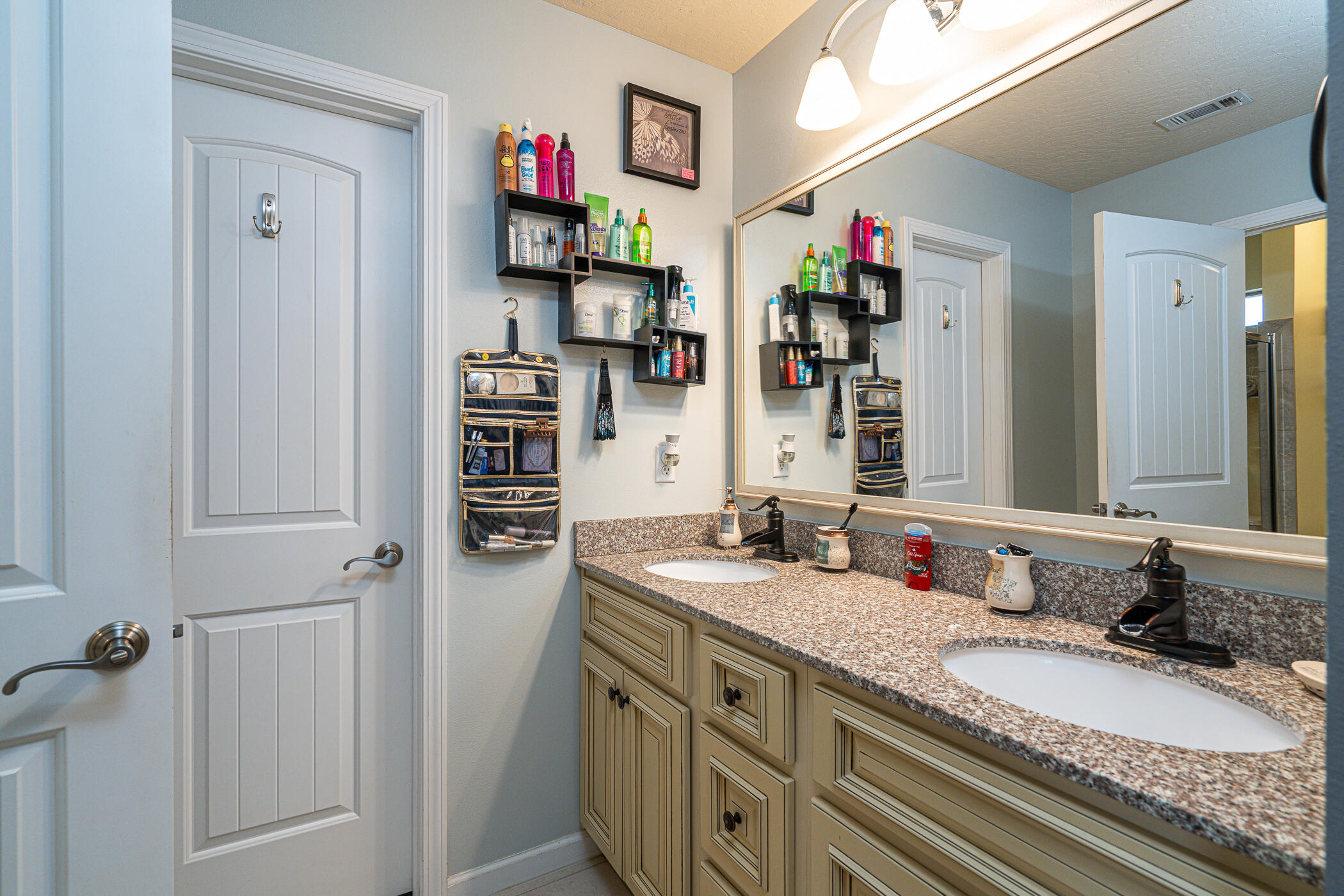5269 Moore Loop Crestview, FL 32536 - Photo 20 of 36 a bathroom with a granite countertop double vanity sink and a mirror