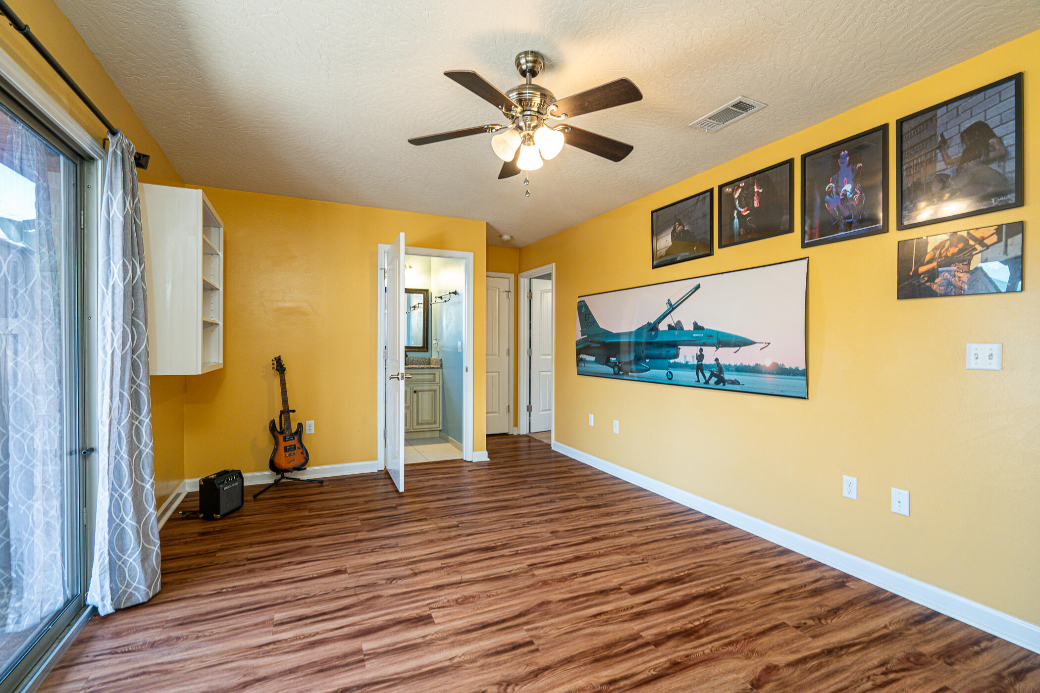 5269 Moore Loop Crestview, FL 32536 - Photo 22 of 36 a view of a room with wooden floor and ceiling fan