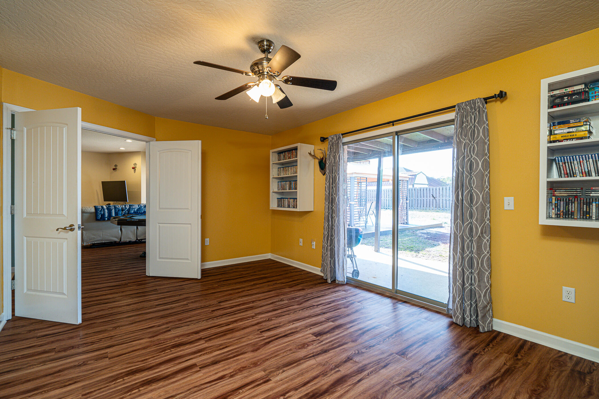 5269 Moore Loop Crestview, FL 32536 - Photo 24 of 36 a view of a livingroom with wooden floor and a ceiling fan