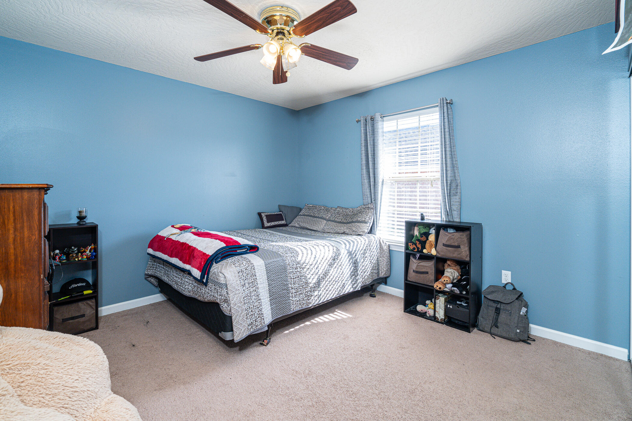 5269 Moore Loop Crestview, FL 32536 - Photo 27 of 36 a bedroom with a bed and a chandelier