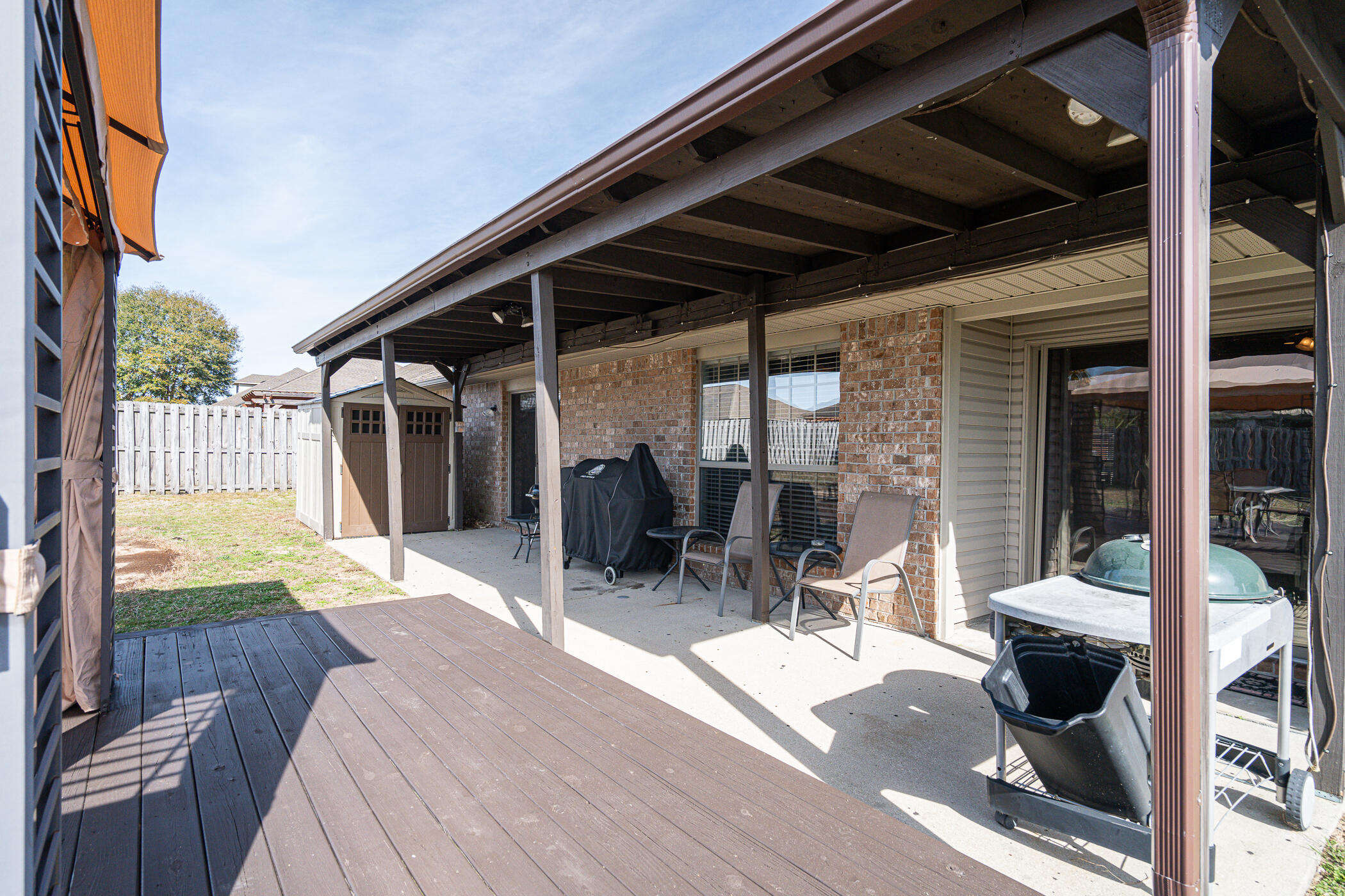5269 Moore Loop Crestview, FL 32536 - Photo 33 of 36 a view of a patio with table and chairs and wooden floor