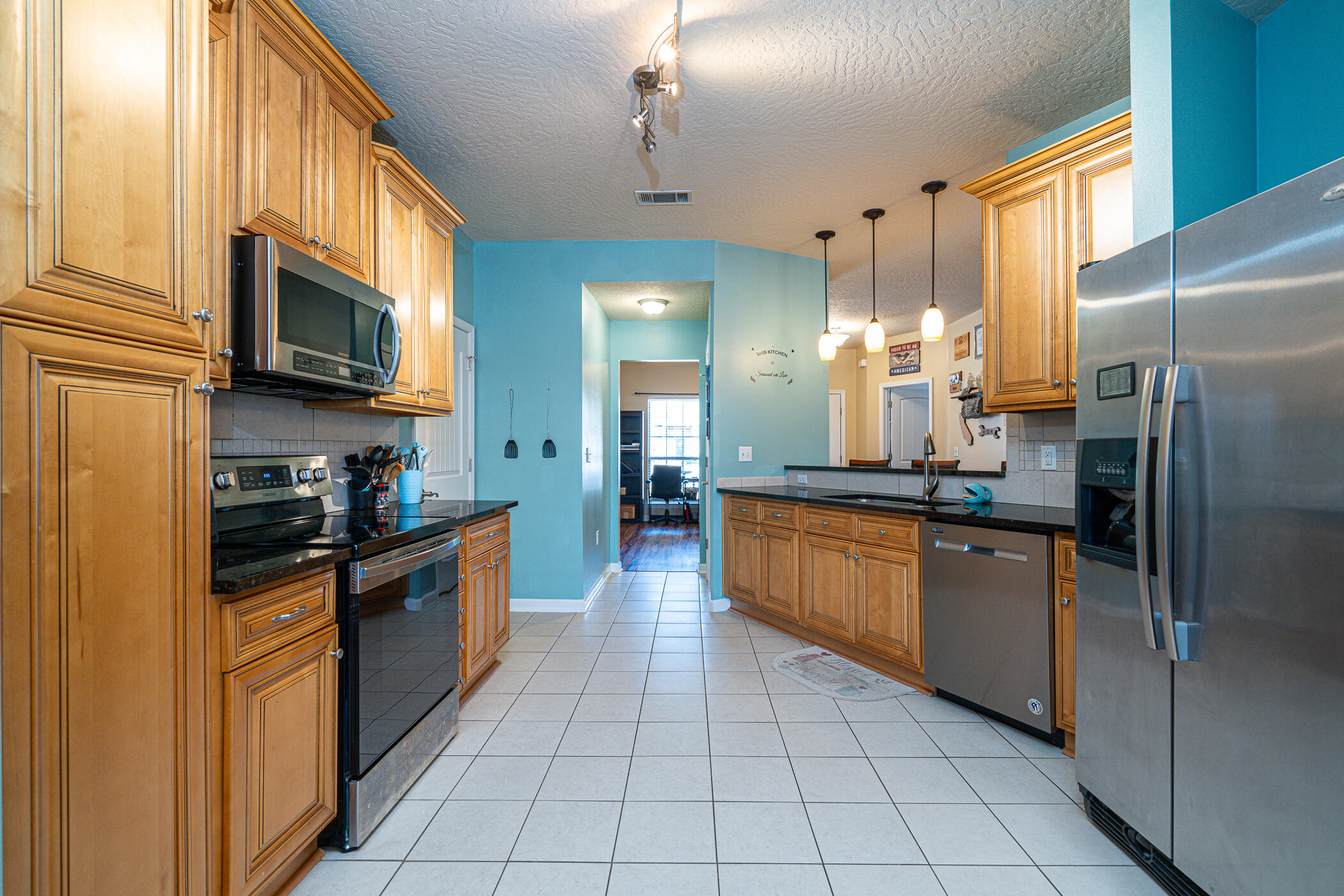 5269 Moore Loop Crestview, FL 32536 - Photo 5 of 36 a kitchen with stainless steel appliances granite countertop a refrigerator a oven a sink dishwasher and granite countertops with cabinets