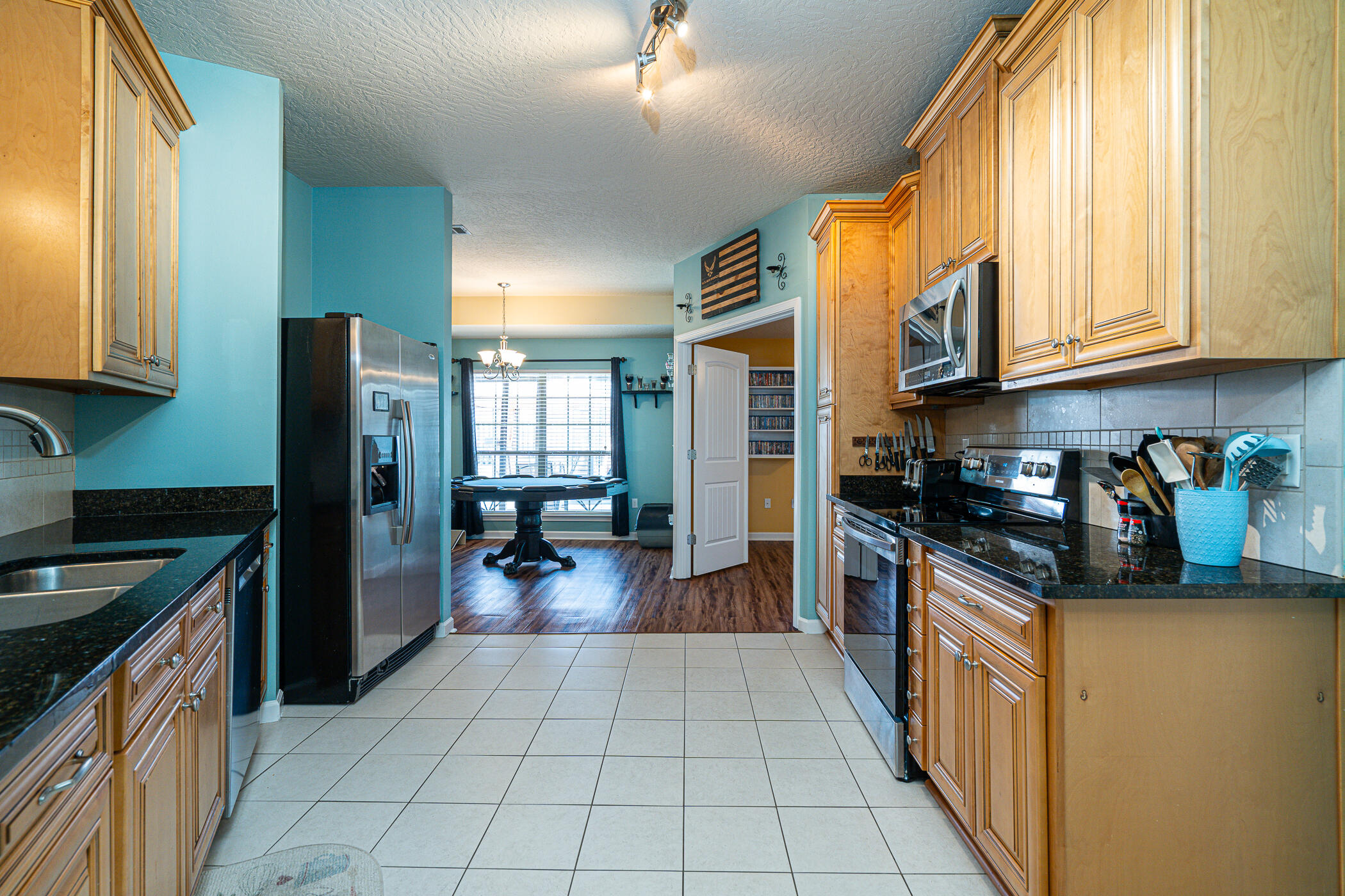 5269 Moore Loop Crestview, FL 32536 - Photo 6 of 36 a kitchen with stainless steel appliances granite countertop a refrigerator and a stove top oven