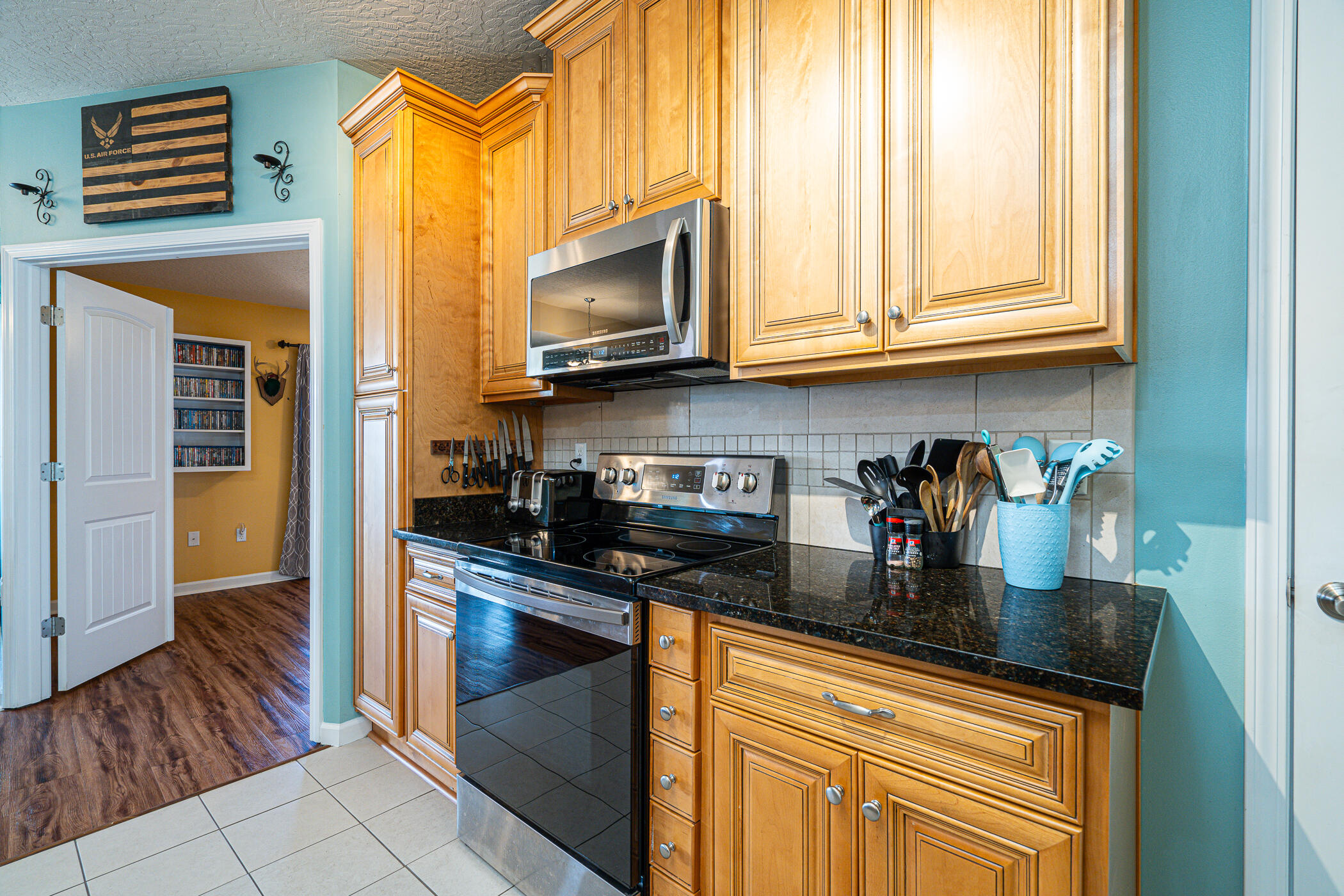 5269 Moore Loop Crestview, FL 32536 - Photo 7 of 36 a kitchen with stainless steel appliances granite countertop a stove a sink and a microwave
