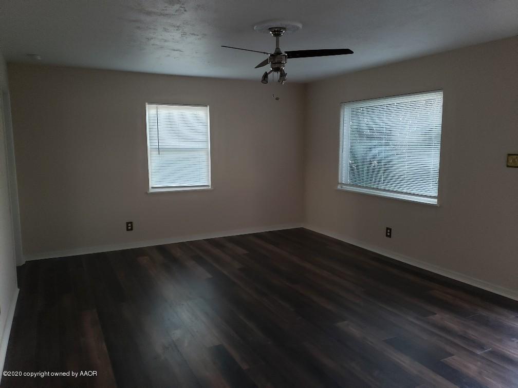 4408 South Ong Street Amarillo, TX 79110 - Photo 2 of 23 a view of an empty room with wooden floor and a window
