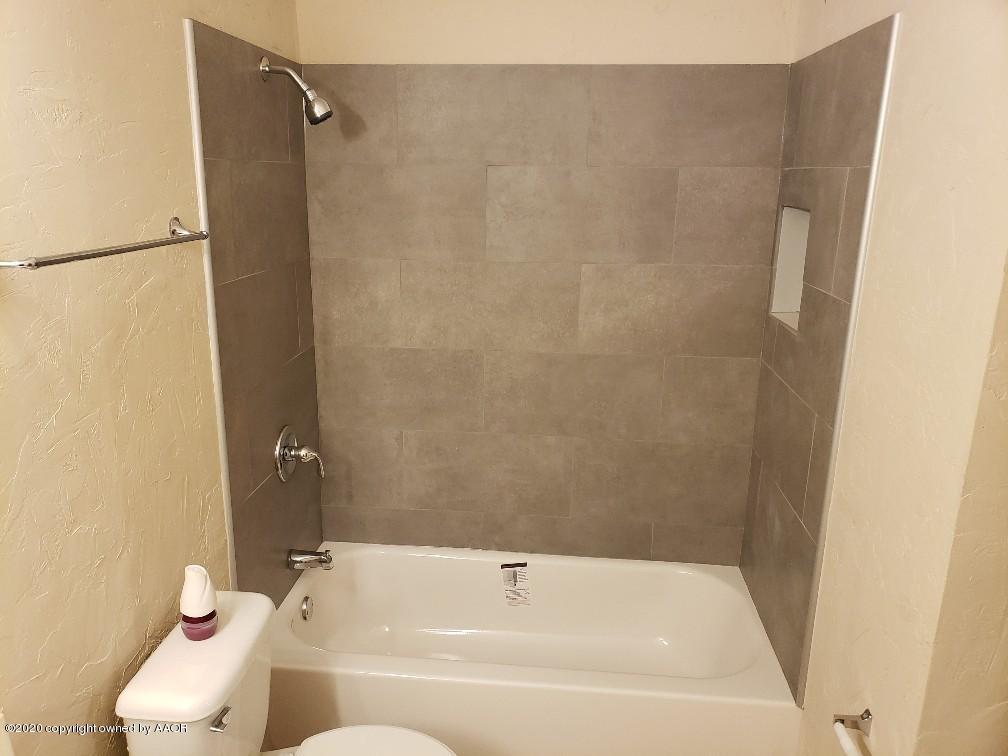 4408 South Ong Street Amarillo, TX 79110 - Photo 12 of 23 a bathroom with a bathtub and shower