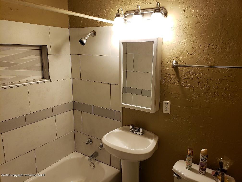 4408 South Ong Street Amarillo, TX 79110 - Photo 18 of 23 a bathroom with a sink toilet and shower