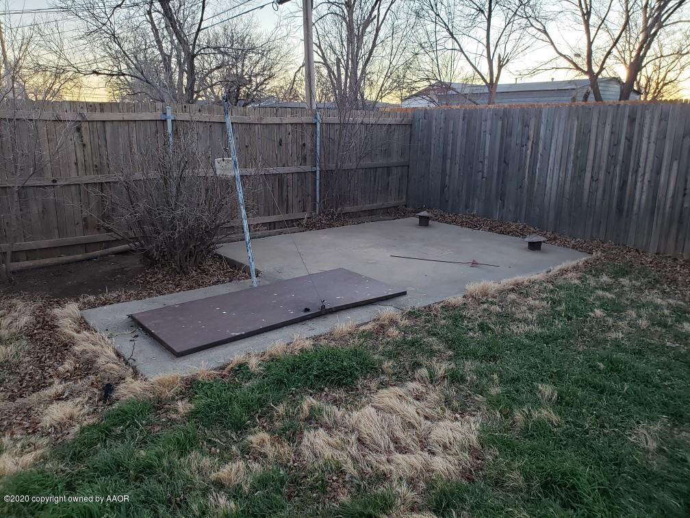 4408 South Ong Street Amarillo, TX 79110 - Photo 22 of 23 a view of a backyard with a trees and wooden fence
