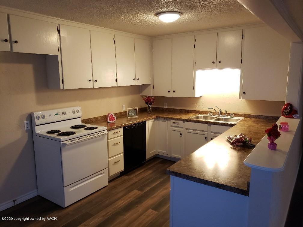 4408 South Ong Street Amarillo, TX 79110 - Photo 4 of 23 a kitchen with a stove sink and cabinets