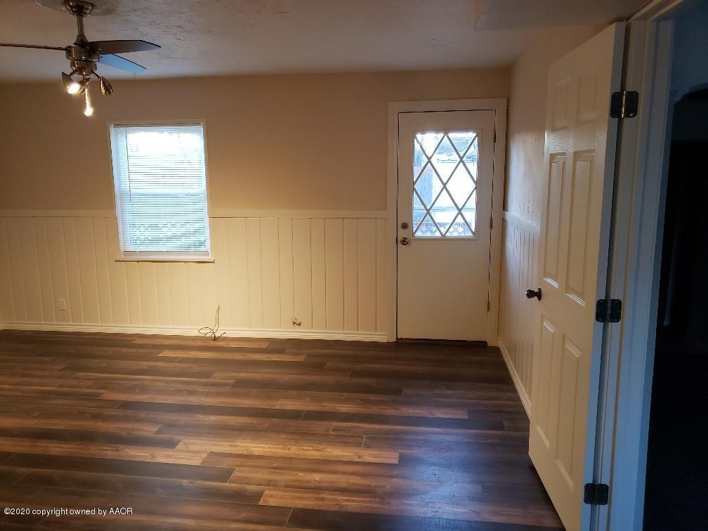 4408 South Ong Street Amarillo, TX 79110 - Photo 7 of 23 an empty room with wooden floor and windows