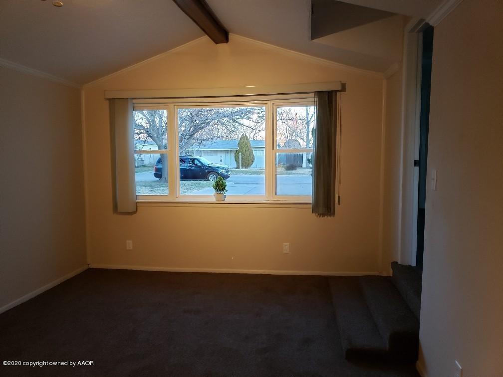 4408 South Ong Street Amarillo, TX 79110 - Photo 9 of 23 an empty room with wooden floor and windows